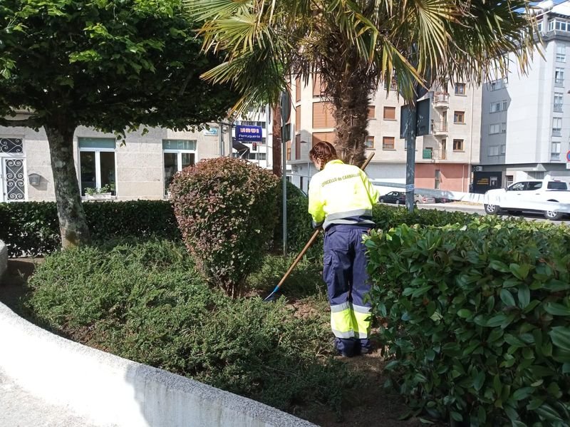 Una operaria limpiando uno de los jardines de Carballiño.
