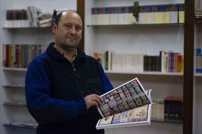José Luis Carnicero enseña un catálogo de sellos en el Liceo (MARTIÑO PINAL).