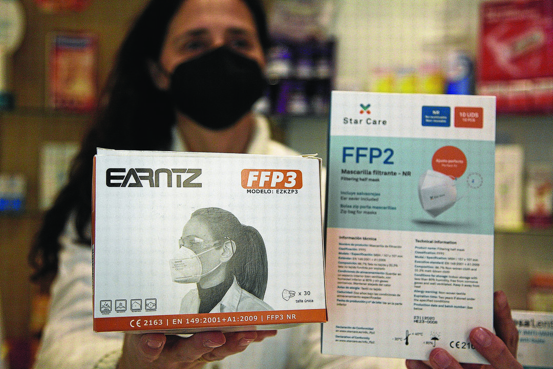 La farmaceútica Emma Martín Cid muestra las mascarillas FFP2 y FFP3.