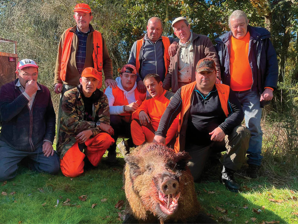 Los cazadores junto al jabalí capturado, un vakamulo de 142 kilos.