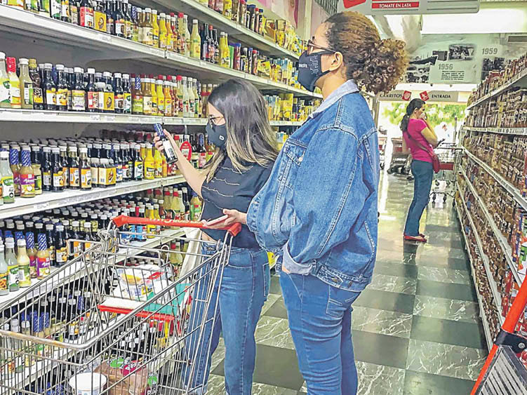 Una mujer y su hija hacen la compra en un supermercado.