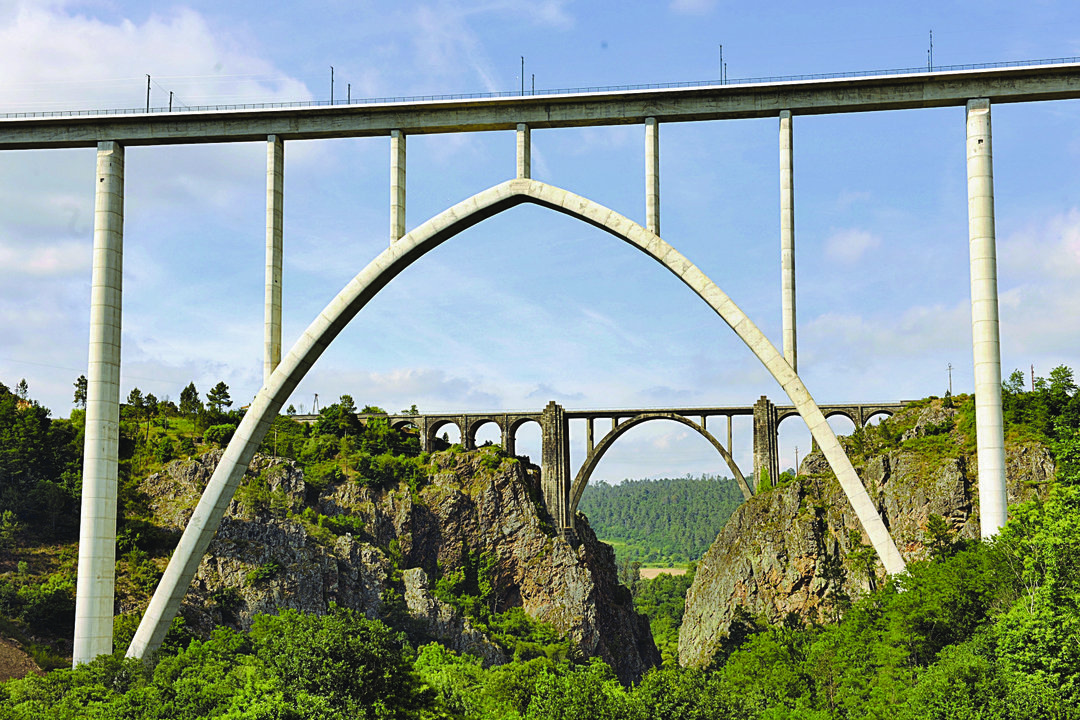 Línea de Ourense a Santiago (al fondo) y AVE discurren en paralelo al cruzar el río Ulla. (ARCHIVO)