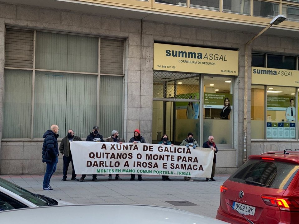 Ocho personas despliegan una pancarta en Ourense.