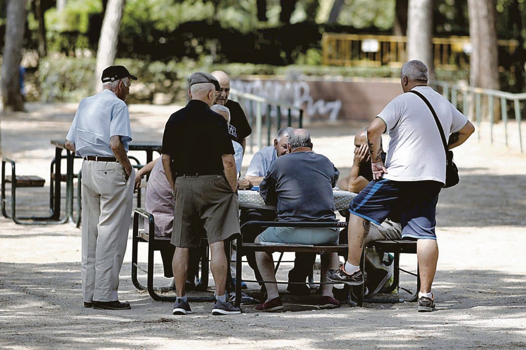Varios pensionistas jugando al dominó en un parque de Madrid.